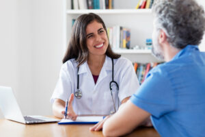 Friendly female doctor talking to patient